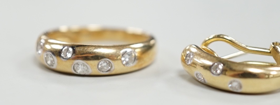 A modern 14k and gypsy set six stone diamond band, size N and a pair of matching earrings, gross weight 8.1 grams.
